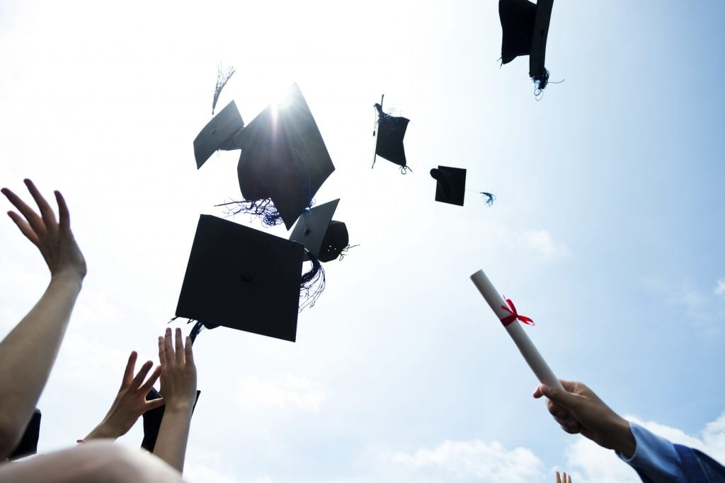 throwing graduation hats – Leadership Academy